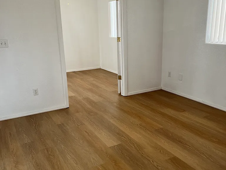 master bedroom with doors to bonus room opened