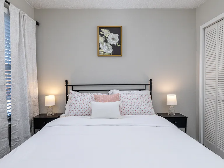 Upstairs Bedroom 2 offers a plush queen bed and cozy carpeted floors_ideal for a restful night's sleep.