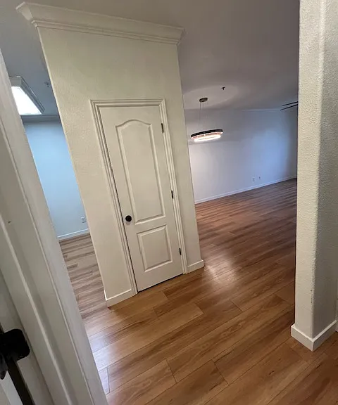 Coat closet from the entry Kitchen in the area to the left dining with beautiful custom light fixture to the right and further to the right is the living area with big ass fan