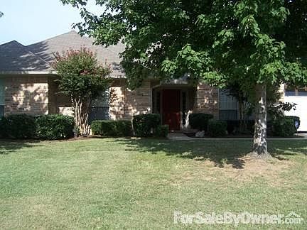 Front of house with two large oak trees provide nice shade.