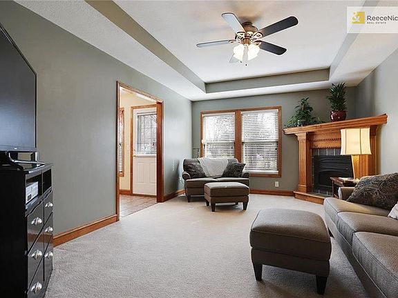View from tiled entryway. Floor plan flows nicely through the kitchen from two different directions.