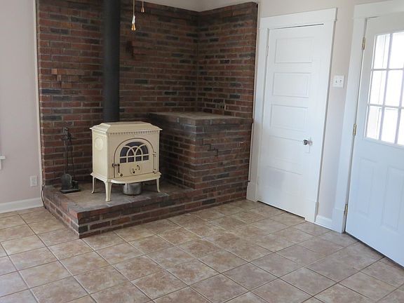 cozy family room with wood burning stove to help lower heating costs