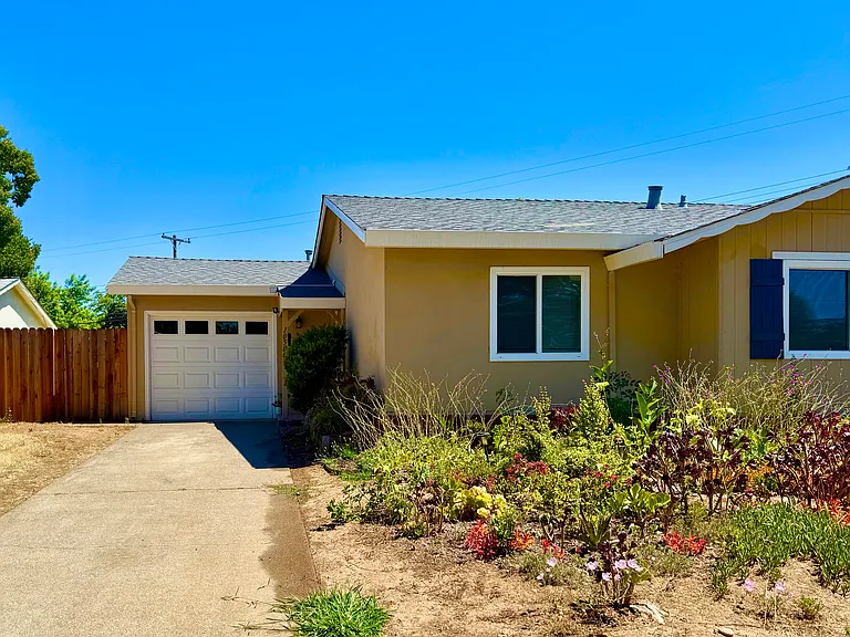 Spacious driveway leading into one car garage