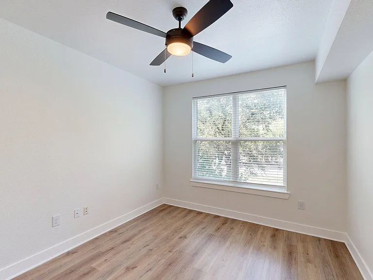 Apartment bedroom with wood style floor.
