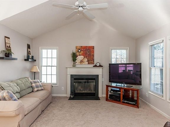 Living room with cathedral ceiling and fireplace