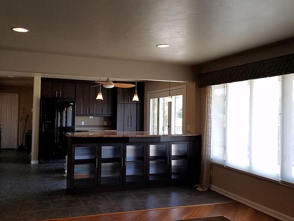 kithcen with breakfast bar off of living room