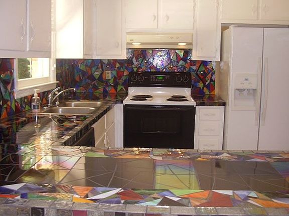 Kitchen with unique glass mosaic countertop.
