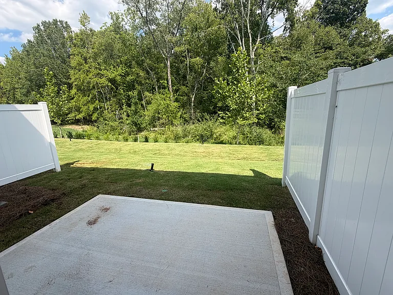 Private Backyard having tree lined