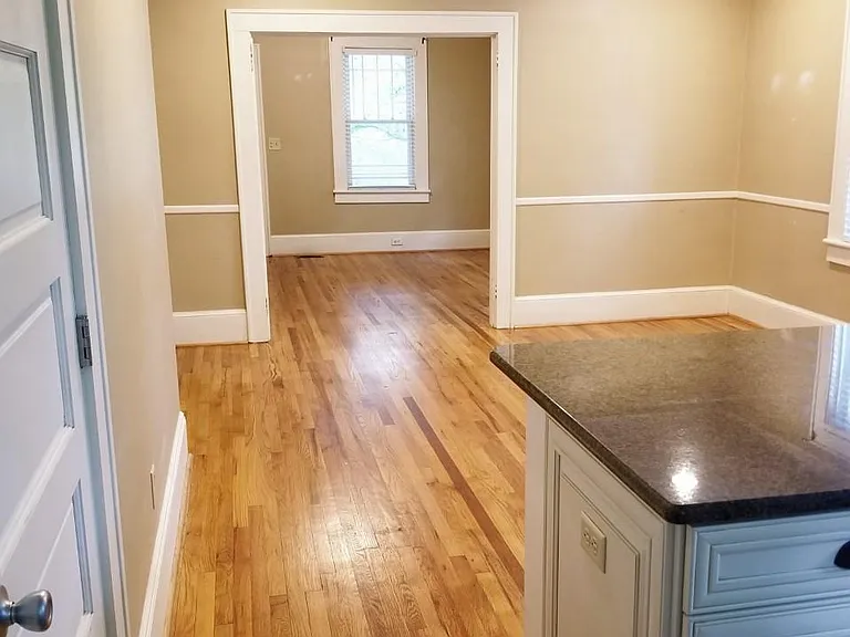 Pennisula between kitchen and dining with bartop seating.
