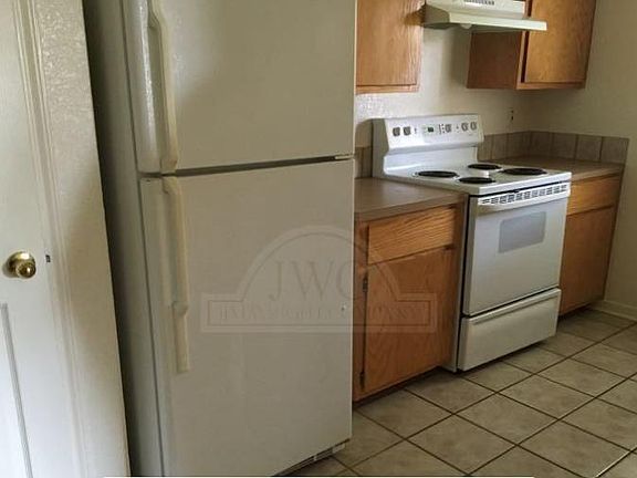 Kitchen comes with refrigerator and a stove.