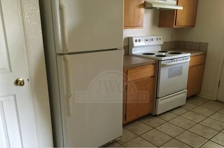 Kitchen comes with refrigerator and a stove.