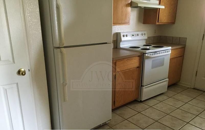 Kitchen comes with refrigerator and a stove.