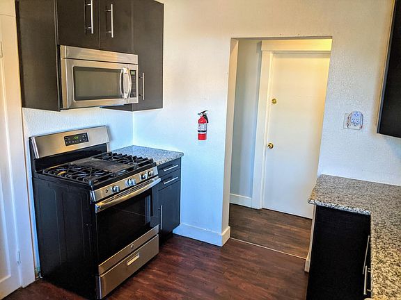 Kitchen. Door in view leads to shared internal stairwell of house to access basement laundry.