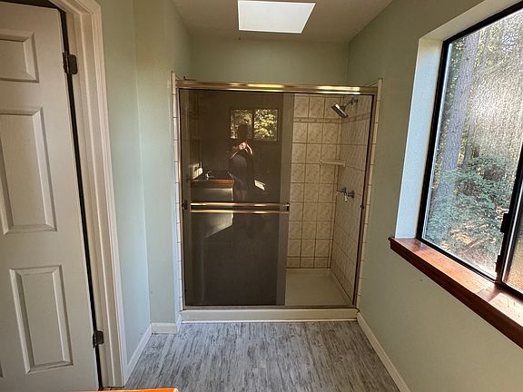 Master bathroom shower with skylight and 2 shower heads, on each side