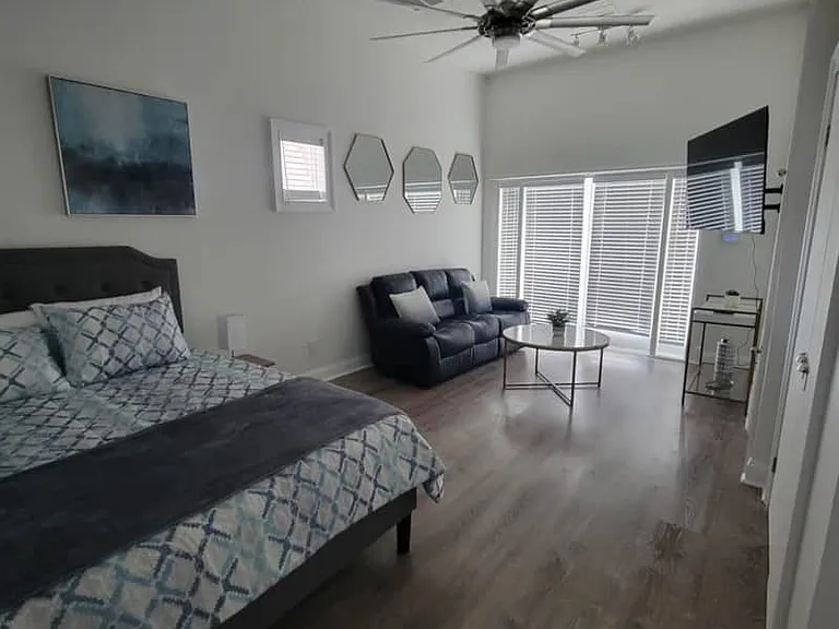 Charming studio with queen bed, cozy seating, and Smart TV.