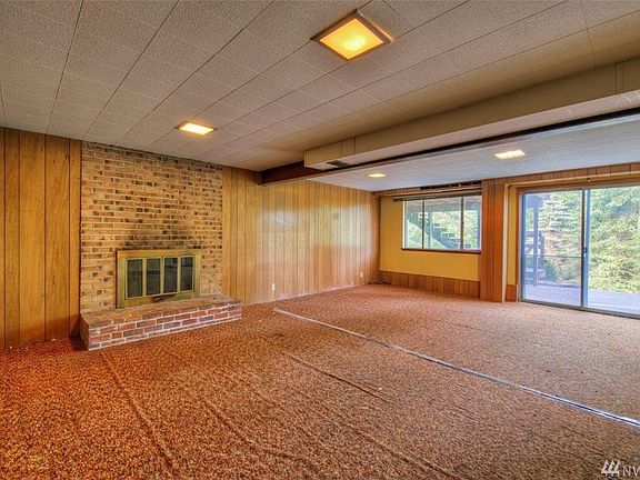 Large family room with Brick fireplace and slider to backyard