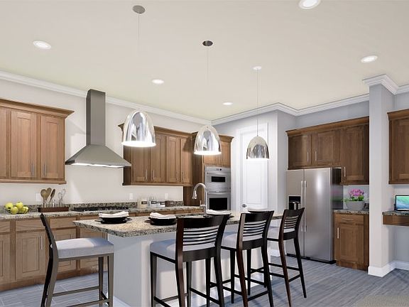 Extensive granite countertops and a center island equip the kitchen for cooking projects large and s