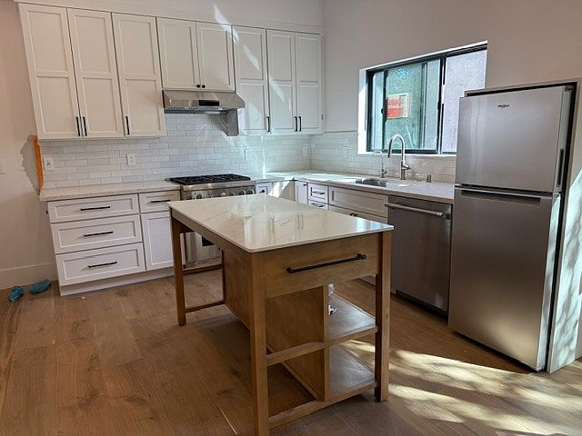 Full kitchen with stainless steel appliances and high end cabinets