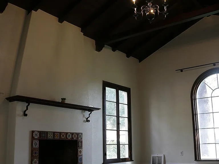 The refined and beautiful front living room with its solid darkwood vaulted ceiling
