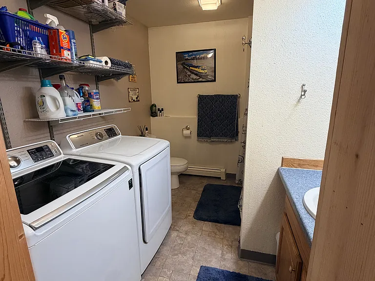 Downstairs full bathroom with washer and dryer