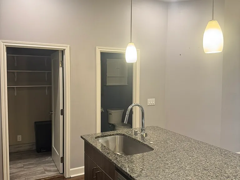 Kitchen with 1/2 bath and laundry/pantry.