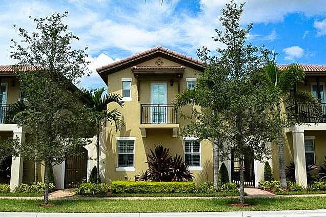 Stunning Mediterranean style townhome with exceptional att