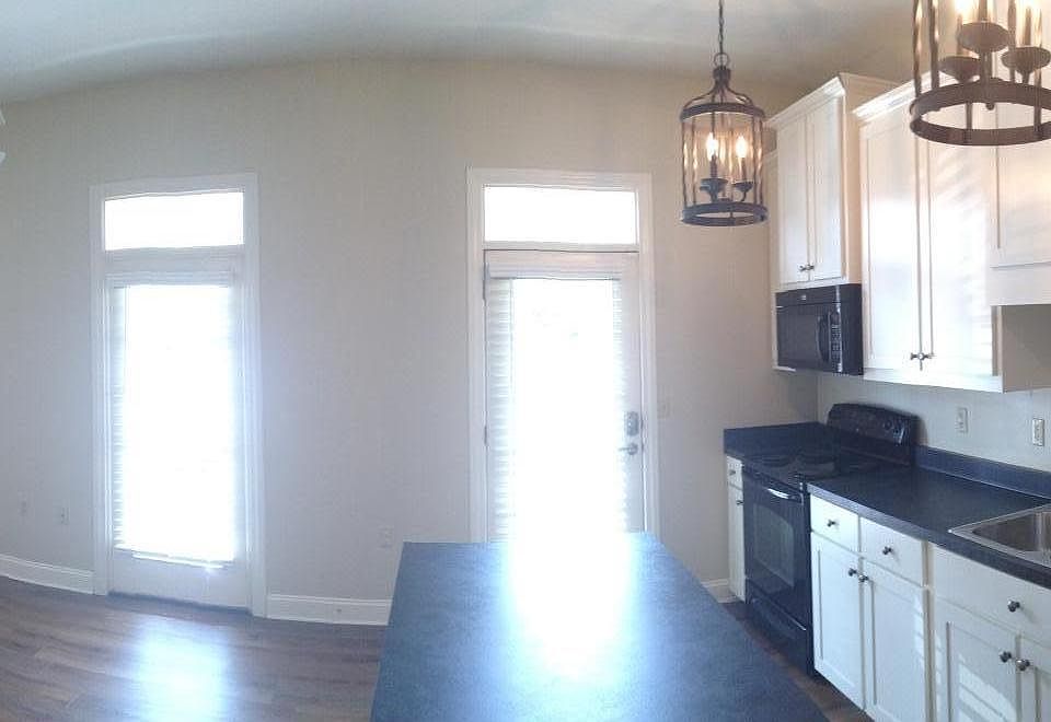 Open concept kitchen/living area with island.