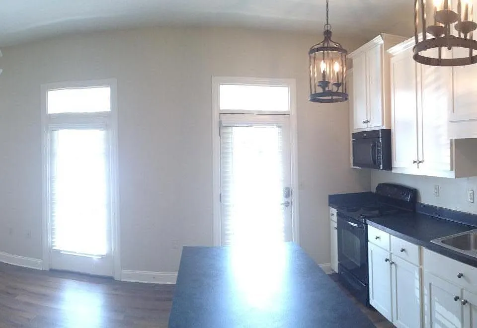 Open concept kitchen/living area with island.