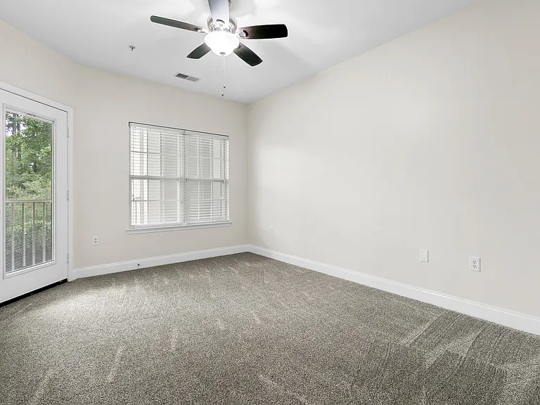 Primary bedroom with access door to screened-in porch/balcony