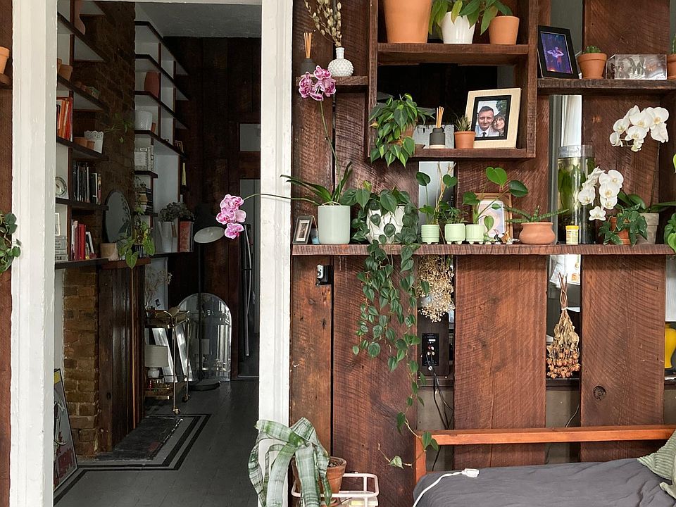 Living room area with built-in shelving for separation from the dining room.