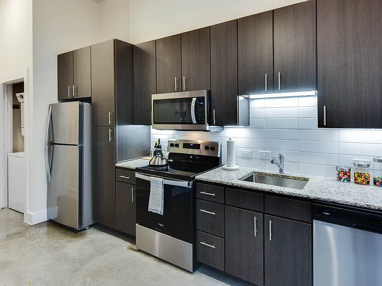 Kitchen with Stainless Steel Appliances and In-home Washer and Dryer