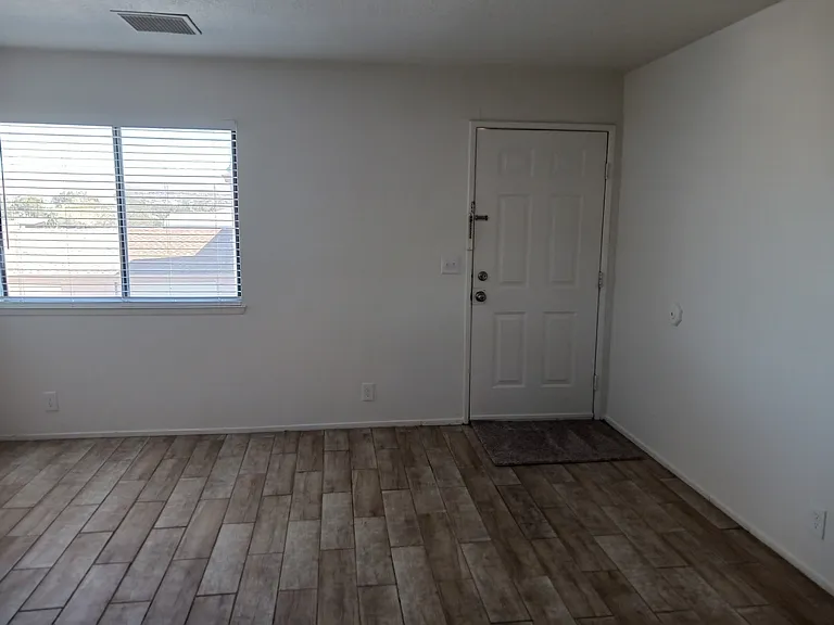 Entry way with tiled living room.