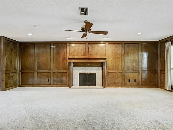 Lots and lots of natural light accent the beautiful black paneling.  Front windows look toward the tennis courts and clubhouse a