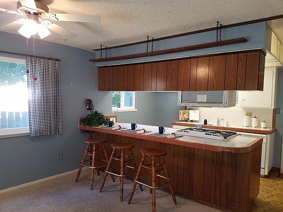 Dining area and kitchen view. Lots of windows offer natural lighting.