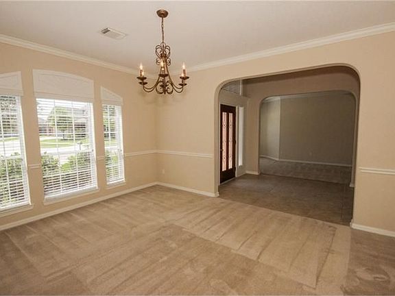 Formal dining room is big enough to fit over-sized furnishings, or sit a large crowd.   Extensive crown moldings and a beautiful wall of windows overlooking the front lawn.