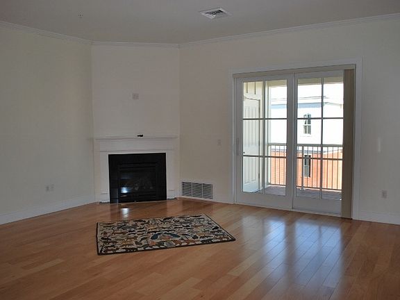Living room with gas fire place and access to balcony