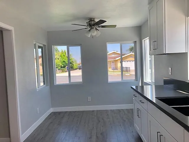 Beautiful Dining Area with new floors, new ceiling fan and new cabinetry
