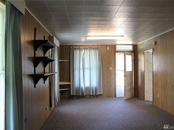 Living room with 3 large windows that will bring in lots of natural light