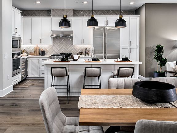 Image showcasing the kitchen from the dining area at Villas Plan 1 model home.