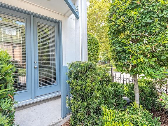 A lovely covered front porch leads to the gated front and side yard.