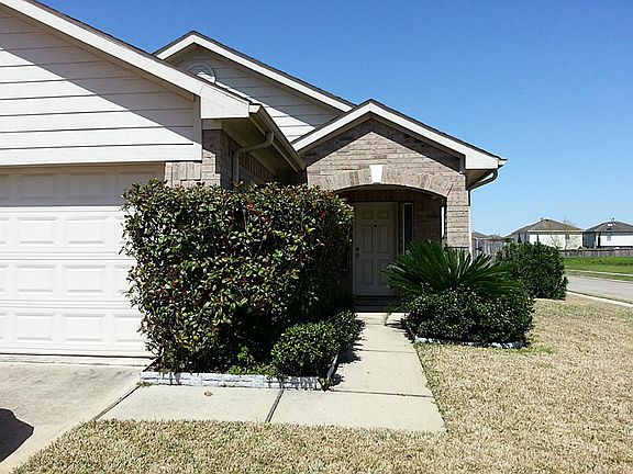 Front view of the home with nicely landscaped front entrance.