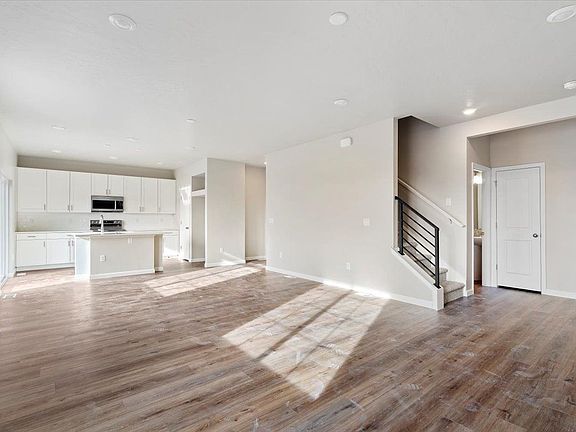 A view of the kiotchen and stairwell from the great room