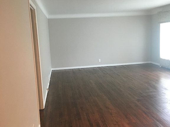 Large living room space, picture window with sight lines towards the dining and kitchen space