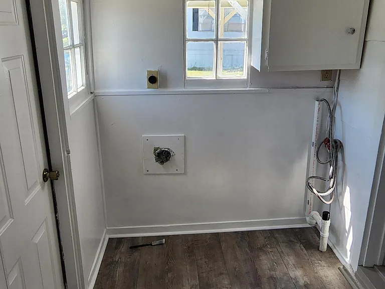 Back porch. Washer/Dryer hookup straight ahead. Exterior door on left leading to deck. Door on right leads into dining room and kitchen area.