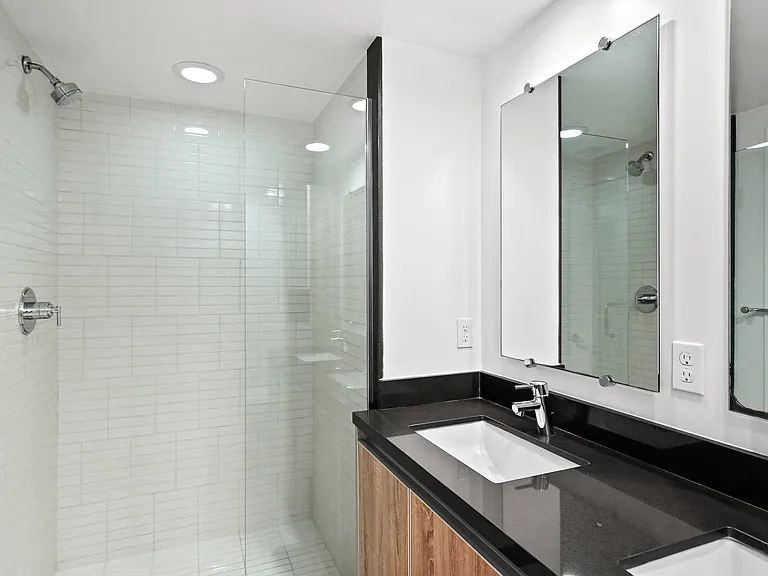Bathroom with Double Sinks and Full-Size Walk-In Shower