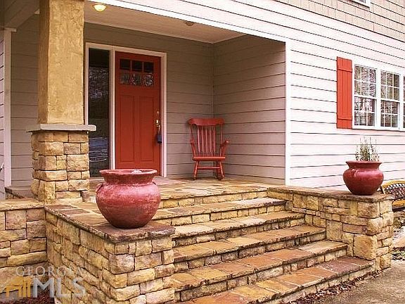 Beautiful stone porch and steps invite you inside.