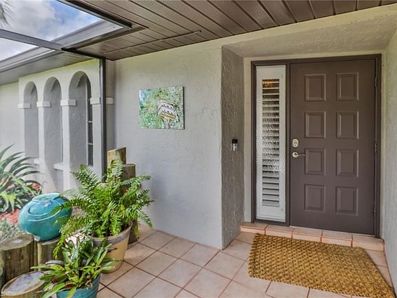 Screened, tiled entry with Ring security monitor.