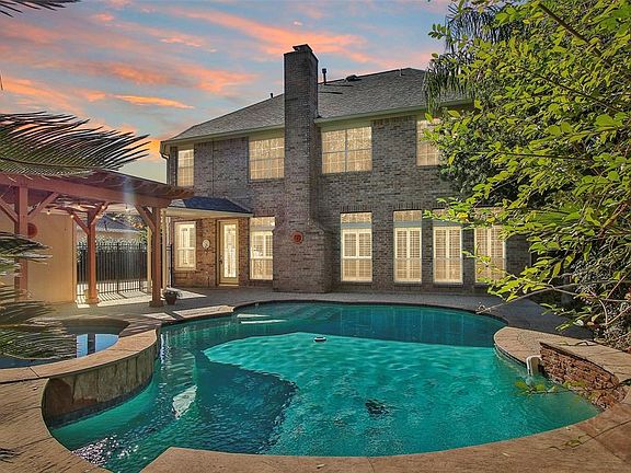 Take a plunge in this sparkling heated pool! And don't worry about dripping through the house- there's a bathroom in the garage!