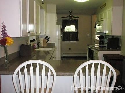 Kitchen : New Corian Counter tops, new cupboards, new appliances sold with house.