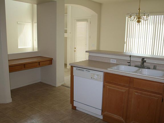 Kitchen w built-in desk looking over Great Room, with Dining